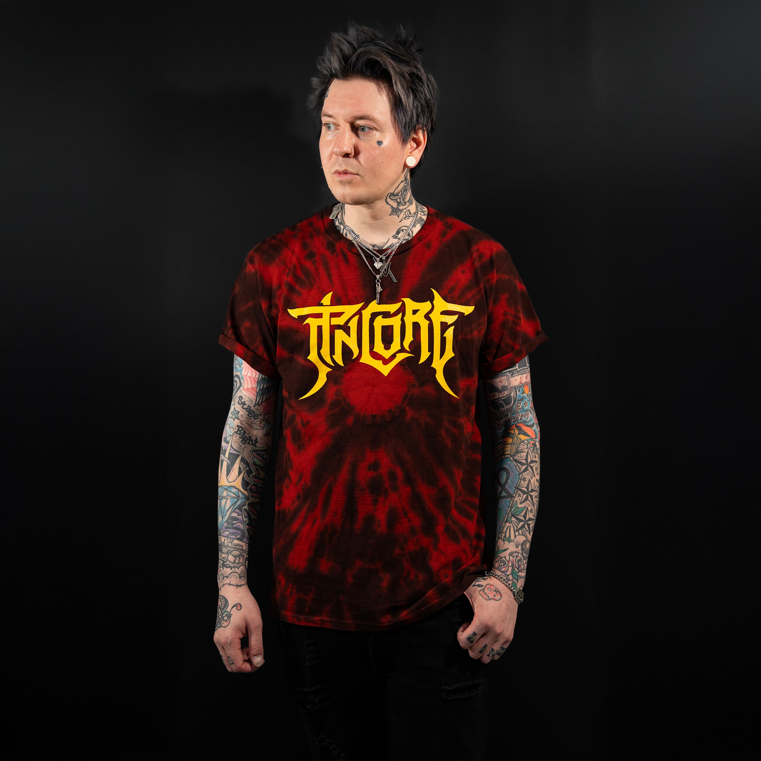 Image of Pincore Merchandise T Shirt red and black tie dye tee with yellow gothic logo worn by tattooed model