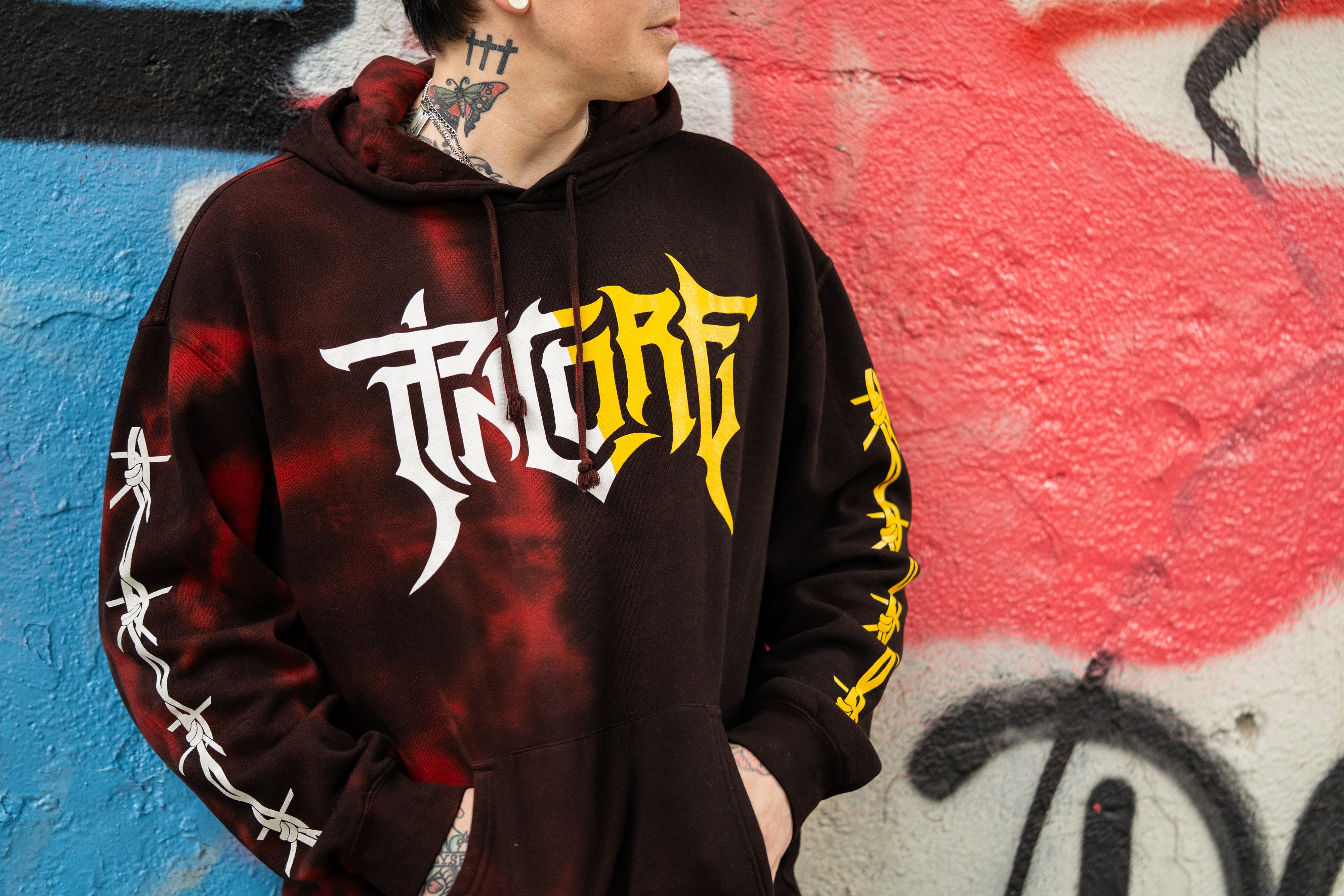 Image of Pincore Merchandise limited edition tie dye hoodie black red with yellow logo and barbed wire sleeves