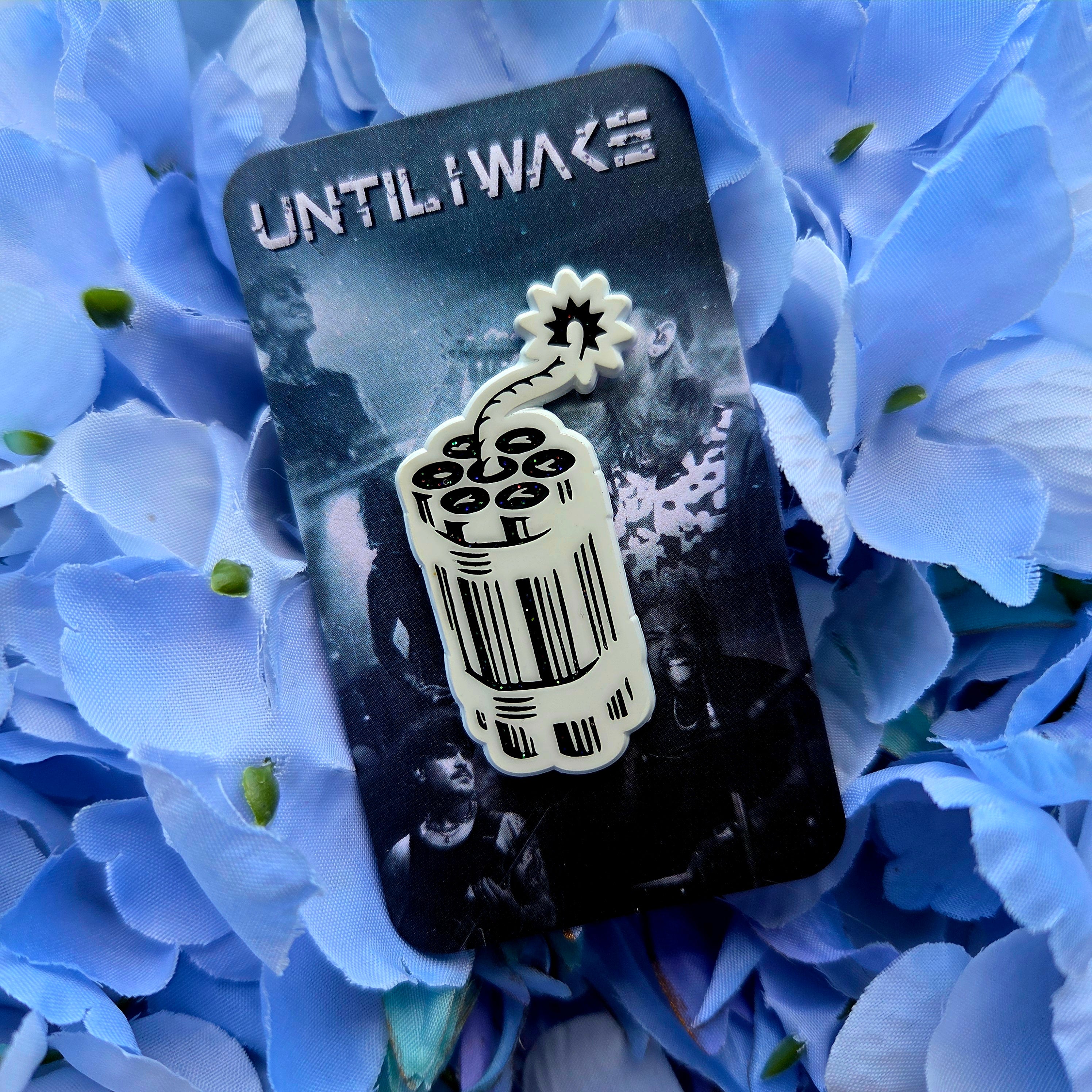 Image of Until I Wake enamel pin by Pincore Merchandise featuring stylized dynamite barcode design on floral background